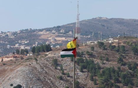 Palestinian and Hezbollah flags flutter in Khiam, near the border with Israel, in southern Lebanon October 9, 2023. REUTERS/Aziz Taher/File Photo