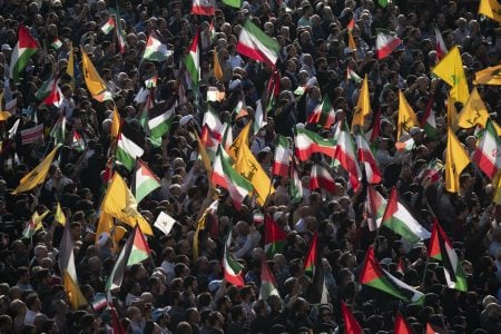 Crowd carrying Palestinian flags, Iran flags, and Lebanon's Hezbollah flags at the Enghelab (Revolution) square during an anti-Israel rally in Tehran, Iran, on October 18, 2023.  (Photo by Morteza Nikoubazl/NurPhoto via Getty Images)